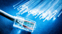 Network cable and optical fibers with lights on blue background.